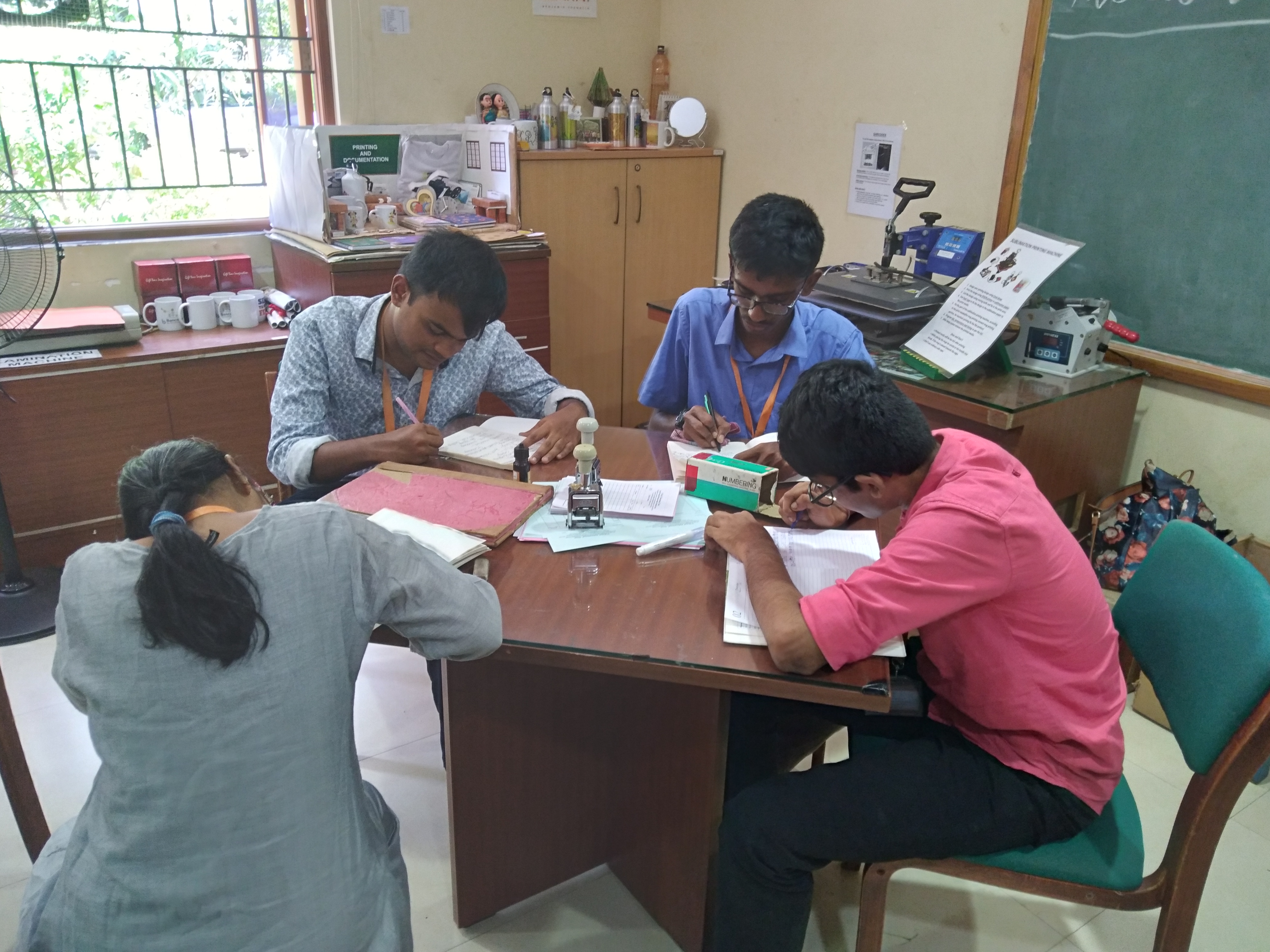 Young adults working together around a table at Youth Empowerment Services