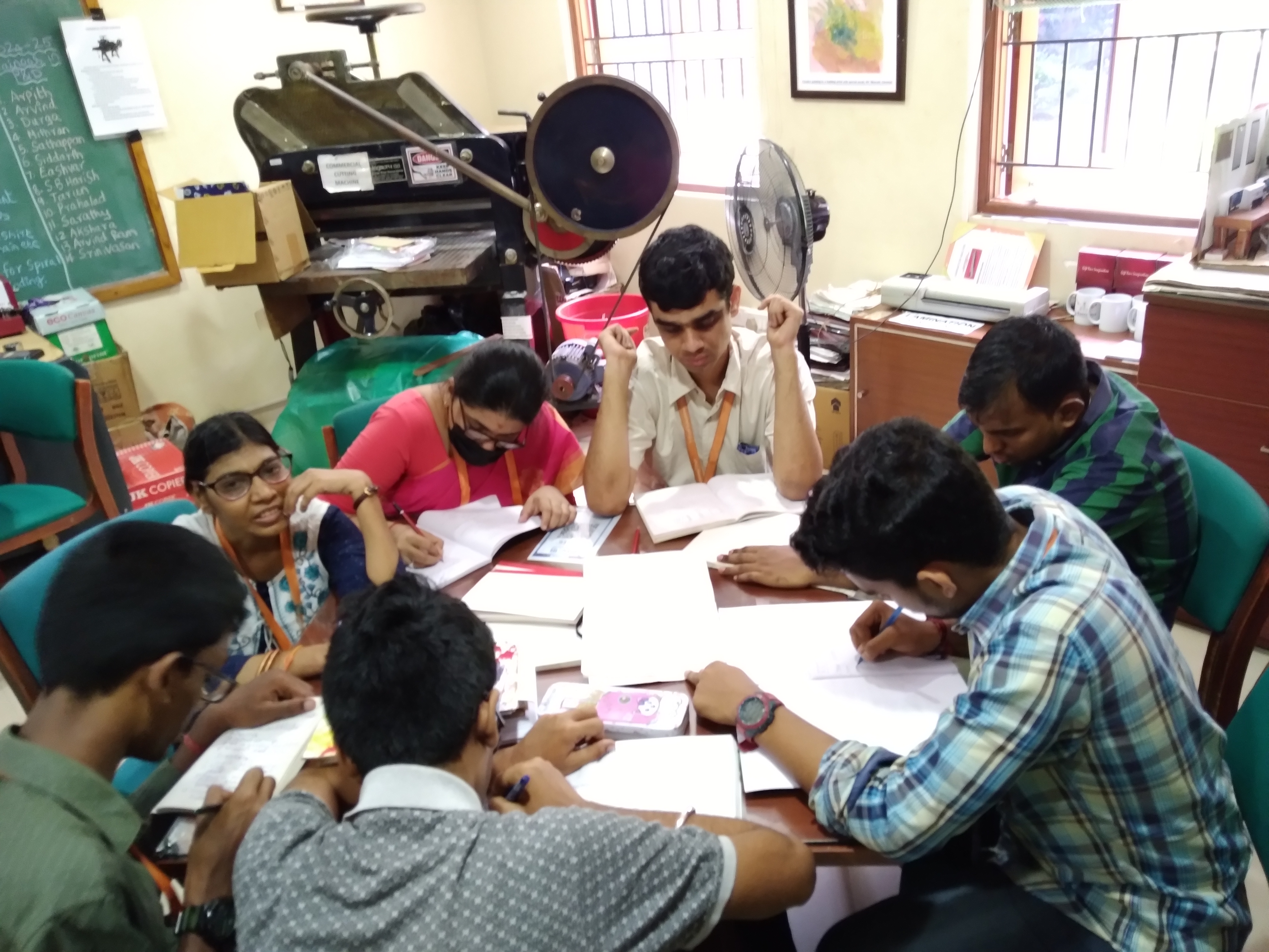 Young adults working together around a table at Youth Empowerment Services